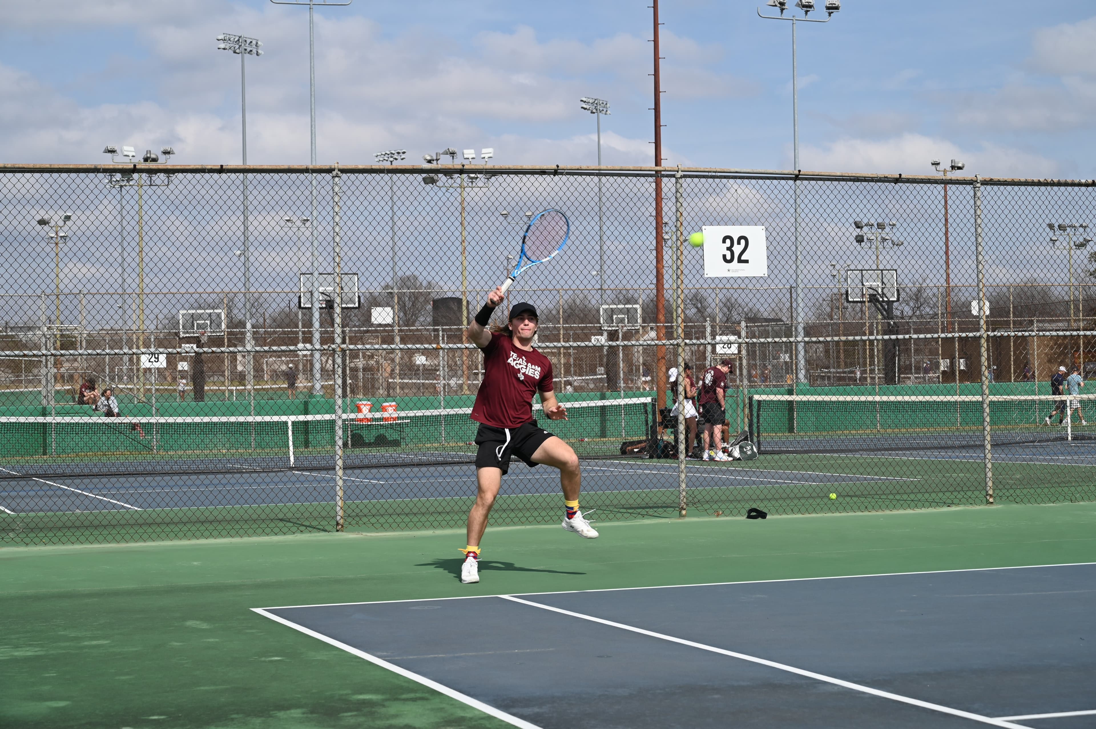 Slone Early hitting a forehand at a Texas A&M tennis event